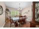 Traditional dining room with chandelier, dining table and chairs, and large sunlit window at 1245 Elm Grove Ln, Greenwood, IN 46143