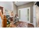 Inviting foyer with a decorative front door, wood flooring, and views of the dining room at 1245 Elm Grove Ln, Greenwood, IN 46143