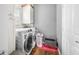 Bright laundry area equipped with modern washer and dryer units, and storage cabinets at 1245 Elm Grove Ln, Greenwood, IN 46143