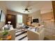 Bright living room with cozy seating, striped rug, ceiling fan, and built-in shelving at 1245 Elm Grove Ln, Greenwood, IN 46143