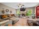 Comfortable living room featuring a brick fireplace, ceiling fan, and large sectional sofa at 1245 Elm Grove Ln, Greenwood, IN 46143