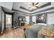 Spacious primary bedroom featuring a tray ceiling, wood floors, and a fireplace at 1245 Elm Grove Ln, Greenwood, IN 46143