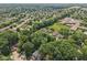 This is an aerial view of a neighborhood, with houses surrounded by lush trees at 1311 Old Hickory Dr, Greenwood, IN 46142
