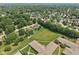 Expansive aerial view of a suburban neighborhood with lush green trees and well-maintained lawns at 1311 Old Hickory Dr, Greenwood, IN 46142
