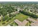 Expansive aerial view of a suburban neighborhood with lush green trees and well-maintained lawns at 1311 Old Hickory Dr, Greenwood, IN 46142
