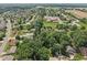 Aerial shot of a residential area featuring lush green trees, well-maintained lawns and a mix of homes at 1311 Old Hickory Dr, Greenwood, IN 46142