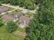 Aerial view of a charming home with mature trees, well-maintained lawn, and inviting outdoor space at 1311 Old Hickory Dr, Greenwood, IN 46142