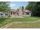 The backyard features a lush lawn, a brick border, and a chimney at 1311 Old Hickory Dr, Greenwood, IN 46142