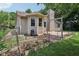 Charming backyard with garden boxes, a small deck, and mature landscaping at 1311 Old Hickory Dr, Greenwood, IN 46142