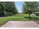 This backyard features a wooden deck, green grass, and a wire archway at 1311 Old Hickory Dr, Greenwood, IN 46142