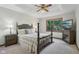 This bedroom features a ceiling fan, neutral carpeting, and a four-poster bed at 1311 Old Hickory Dr, Greenwood, IN 46142
