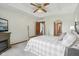 This bedroom features a tray ceiling, ceiling fan, and neutral carpeting at 1311 Old Hickory Dr, Greenwood, IN 46142