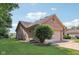 Side view of a brick and siding house with a well-kept lawn and mature landscaping at 1311 Old Hickory Dr, Greenwood, IN 46142