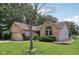 Beautiful brick and siding home featuring a well-maintained lawn and mature trees at 1311 Old Hickory Dr, Greenwood, IN 46142