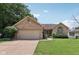 Charming brick home with well-manicured lawn and a two-car garage on a sunny day at 1311 Old Hickory Dr, Greenwood, IN 46142