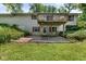 Exterior view of a two-story home with a wooden deck, a door to the basement, and mature trees at 1350 Inverness Farms Rd, Martinsville, IN 46151
