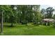 Spacious backyard with lush lawn, mature trees, and wooded surroundings at 1350 Inverness Farms Rd, Martinsville, IN 46151