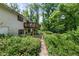 Exterior view of a two story home with a wooden deck overlooking a private backyard with mature trees at 1350 Inverness Farms Rd, Martinsville, IN 46151