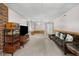 Finished basement with neutral carpet, decorative pillows on sofa, and modern entertainment center at 1350 Inverness Farms Rd, Martinsville, IN 46151