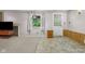 Partially finished basement featuring tiled flooring, a window with natural light, and a white exterior door at 1350 Inverness Farms Rd, Martinsville, IN 46151