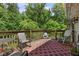 Back deck featuring an outdoor rug, rocking chairs, patio furniture, and a charming water fountain at 1350 Inverness Farms Rd, Martinsville, IN 46151