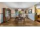 Charming dining room with a vintage chandelier, elegant hutch and beautiful wood flooring at 1350 Inverness Farms Rd, Martinsville, IN 46151