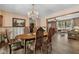 Open-concept dining room leading to the living room with hardwood floors and lots of natural light at 1350 Inverness Farms Rd, Martinsville, IN 46151
