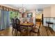 A bright dining room with a chandelier, wood table and view of the leafy green yard at 1350 Inverness Farms Rd, Martinsville, IN 46151