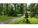 Long driveway leading through lush greenery to a secluded property, offering privacy and a serene setting at 1350 Inverness Farms Rd, Martinsville, IN 46151