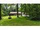 Quaint home nestled among mature trees, featuring a well-kept lawn and charming vintage water well at 1350 Inverness Farms Rd, Martinsville, IN 46151