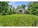 Detached garage surrounded by lush greenery and a well-maintained lawn offering a private setting at 1350 Inverness Farms Rd, Martinsville, IN 46151