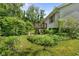 View of the exterior of the house with a wooden deck and lush landscaping at 1350 Inverness Farms Rd, Martinsville, IN 46151