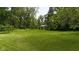 Expansive, well-maintained front lawn surrounded by mature trees, providing a picturesque and serene setting at 1350 Inverness Farms Rd, Martinsville, IN 46151