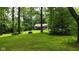 Scenic front yard with mature trees and a charming wishing well feature at 1350 Inverness Farms Rd, Martinsville, IN 46151