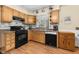 Galley kitchen with oak cabinets, stainless steel appliances and laminate floors at 1350 Inverness Farms Rd, Martinsville, IN 46151