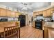 Kitchen featuring wood floors, oak cabinets, stainless steel appliances, and eat-in table at 1350 Inverness Farms Rd, Martinsville, IN 46151