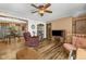 Cozy living room featuring wood-look floors, a ceiling fan, and comfortable seating, with an open dining area at 1350 Inverness Farms Rd, Martinsville, IN 46151