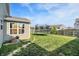 Spacious backyard with green grass, a trampoline, and a view of neighboring houses at 1375 Crabapple Rd, Franklin, IN 46131