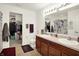 Well-lit bathroom features a double sink vanity, neutral tile flooring, and walk-in closet at 1375 Crabapple Rd, Franklin, IN 46131