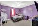 This purple bedroom is decorated with lovely accents and a cozy spot for relaxation and rest at 1375 Crabapple Rd, Franklin, IN 46131
