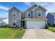 Charming two-story home featuring a two-car garage and well-maintained lawn at 1375 Crabapple Rd, Franklin, IN 46131