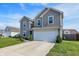 Charming two-story home featuring a two-car garage and well-maintained lawn at 1375 Crabapple Rd, Franklin, IN 46131