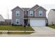 Charming two-story home with a well-maintained lawn and attached two car garage at 1375 Crabapple Rd, Franklin, IN 46131