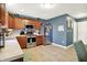 Well-lit kitchen featuring stainless steel appliances, wood cabinets, and neutral-colored tile backsplash at 1375 Crabapple Rd, Franklin, IN 46131