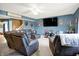 Spacious living room with large, comfortable leather furniture and dark blue walls at 1375 Crabapple Rd, Franklin, IN 46131
