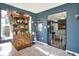 Bright sunroom with vintage cabinet, natural light, tiled flooring, and view of backyard at 1375 Crabapple Rd, Franklin, IN 46131