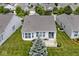 Charming home with a patio, surrounded by a white picket fence and lush greenery at 15937 Marsala Dr, Fishers, IN 46037