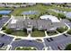 Aerial view showcasing the community clubhouse, pool, tennis courts, pond and manicured landscaping at 15937 Marsala Dr, Fishers, IN 46037