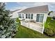 Charming backyard with a patio set, surrounded by a white picket fence and lush greenery at 15937 Marsala Dr, Fishers, IN 46037