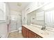 Bathroom with double vanity, large mirror, and glass-enclosed shower at 15937 Marsala Dr, Fishers, IN 46037